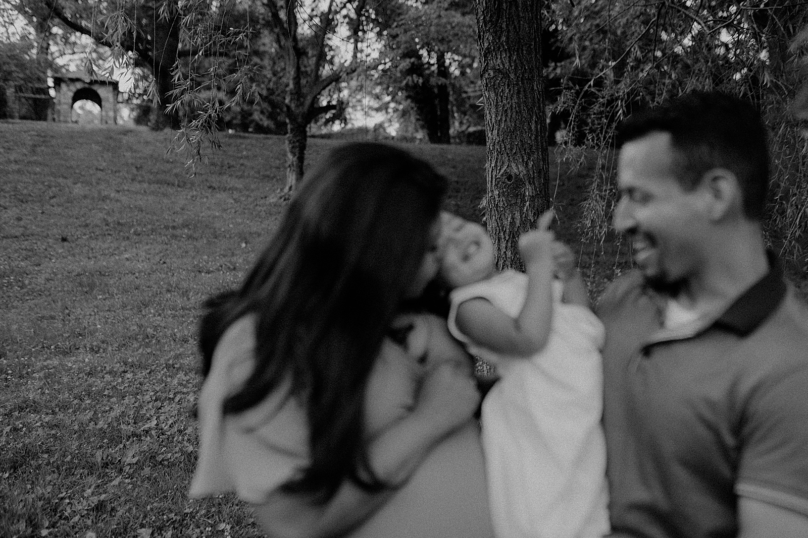 Blurry B&W of Parents holding daughter together