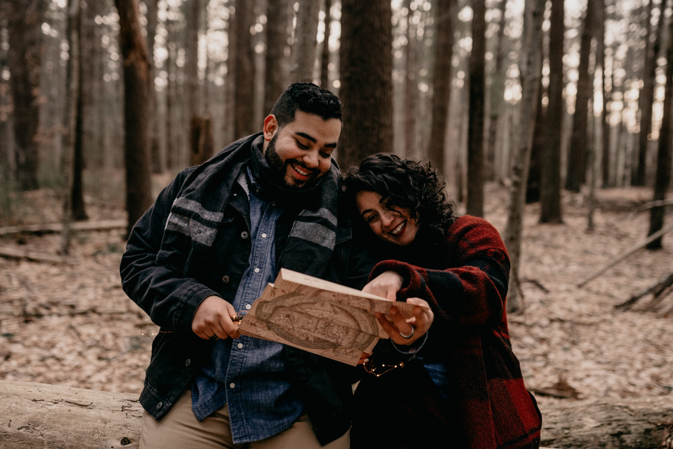 Couple holding wizard wands from Harry Potter at Engagement Session on Long Island, NY