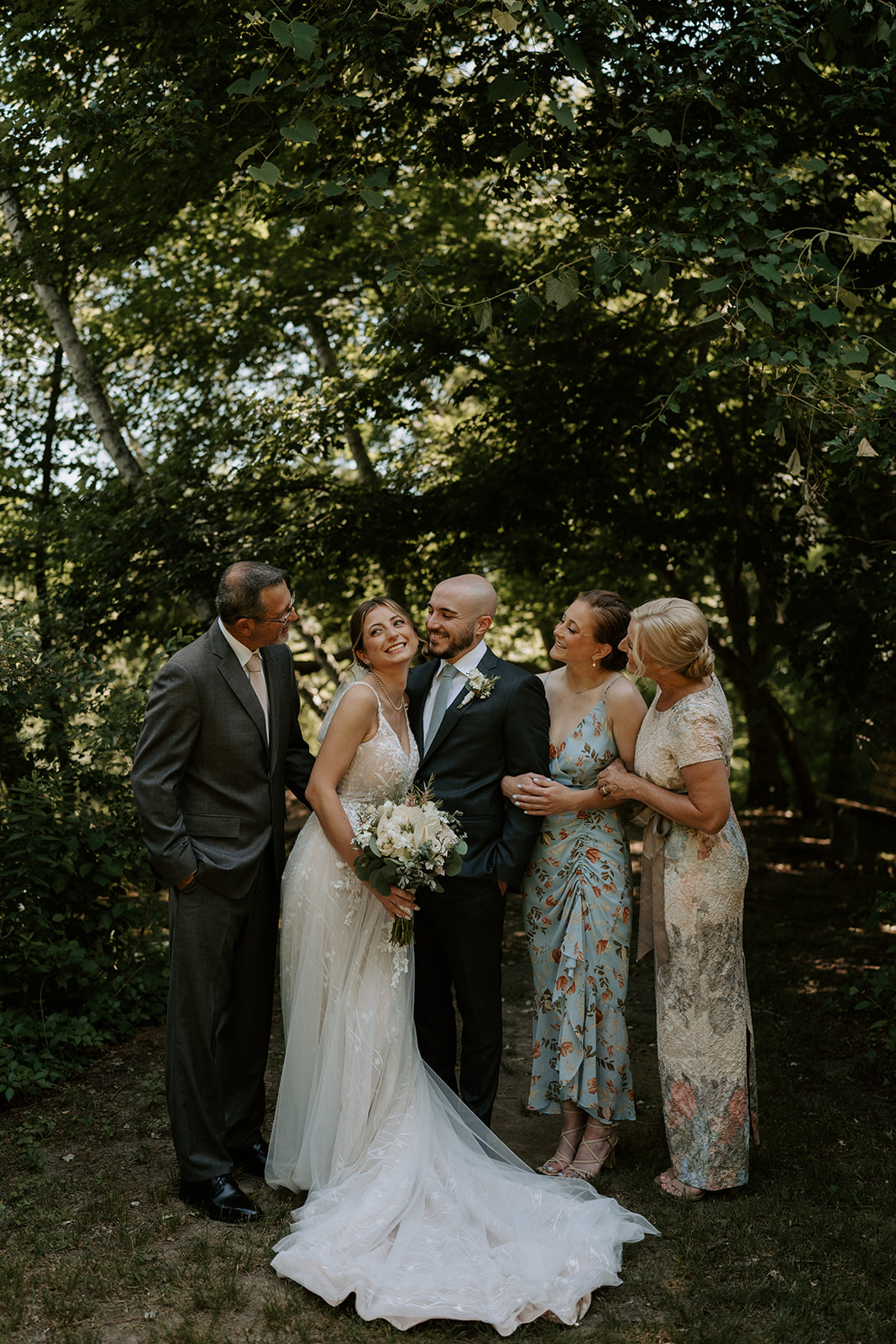 bride and groom with family laughing