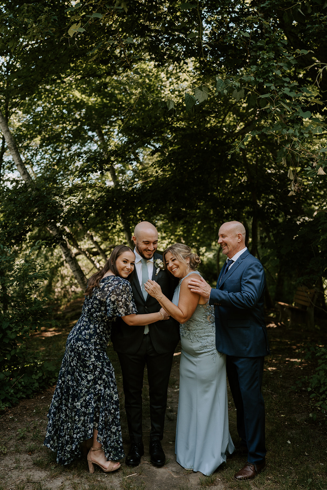 Groom being hugged by family