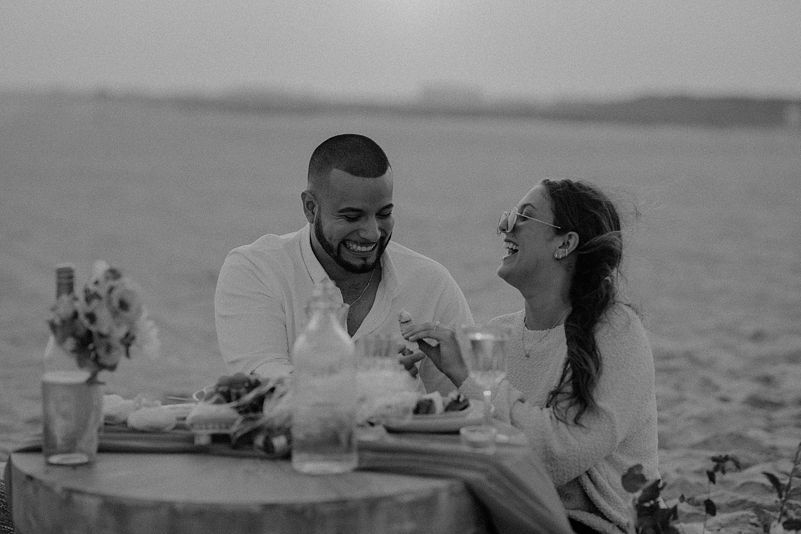 B&W couple eating together and celebrating engagement