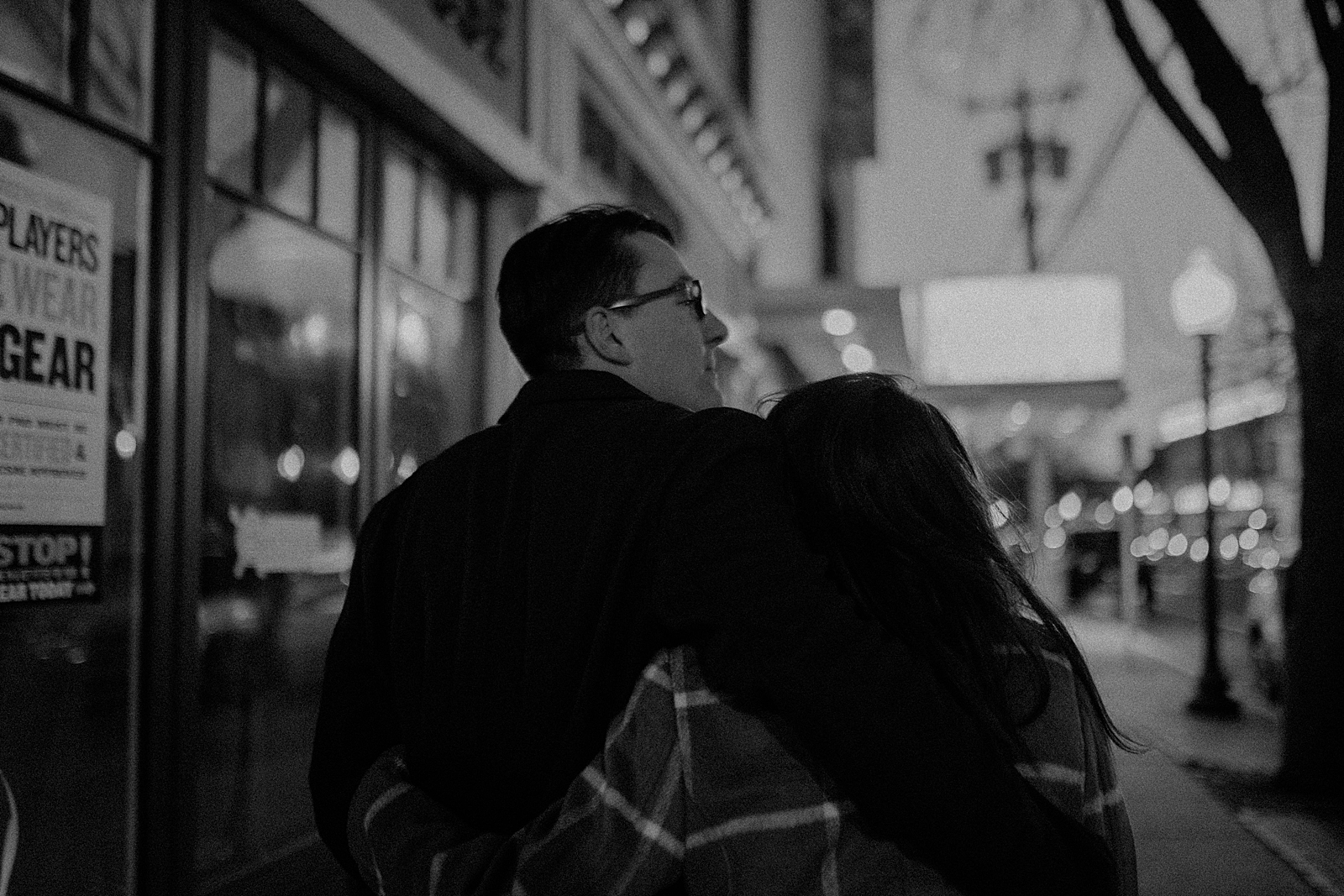 B&W Couple with arms around each other from behind